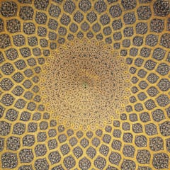 Looking straight up into a tiled dome: rows of lemon-shaped medallions in gold and blue grow smaller as they spiral toward a bright center.